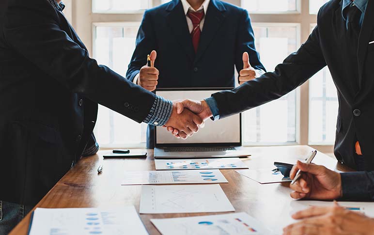 Business people shake hands while negotiating a business deal. Concept of dispute resolution and mediation.